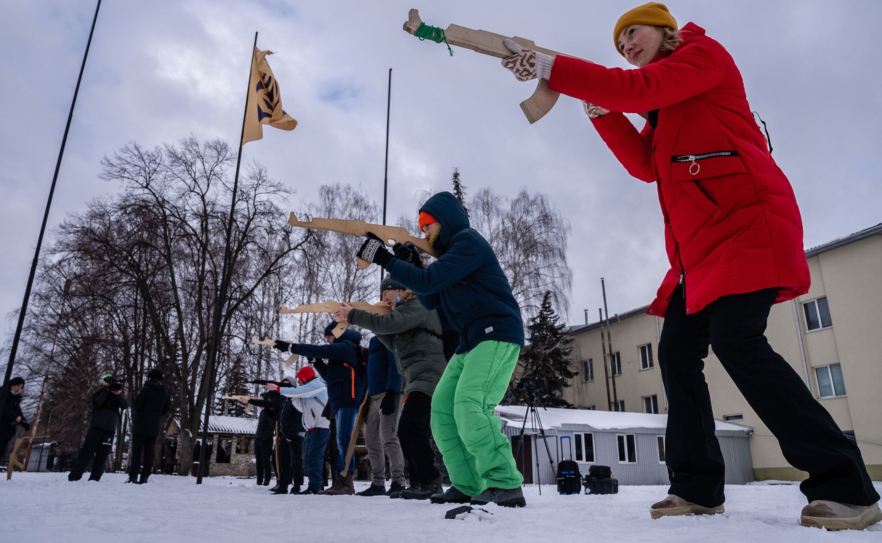 Civilians use wooden mock rifles as they learn combat tactics in Kyiv, Ukraine, on Sunday, January 30.