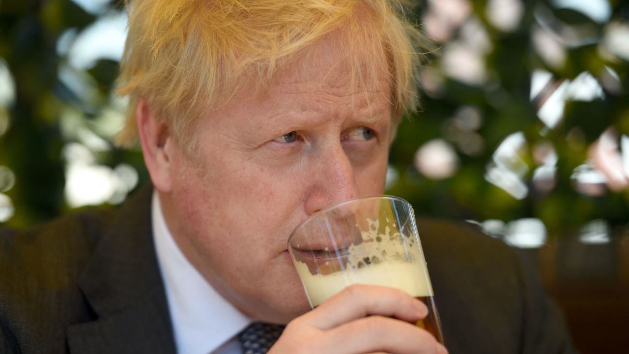Boris Johnson sips a pint of beer at a pub in Wolverhampton, central England, on April 19, 2021, while campaigning for   local elections.