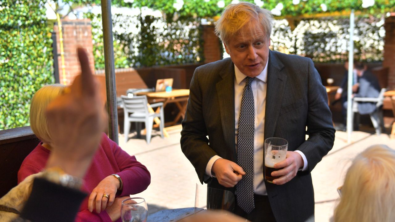 Prime Minister Johnson with customers in the beer garden during a visit to a pub on April 19, 2021.