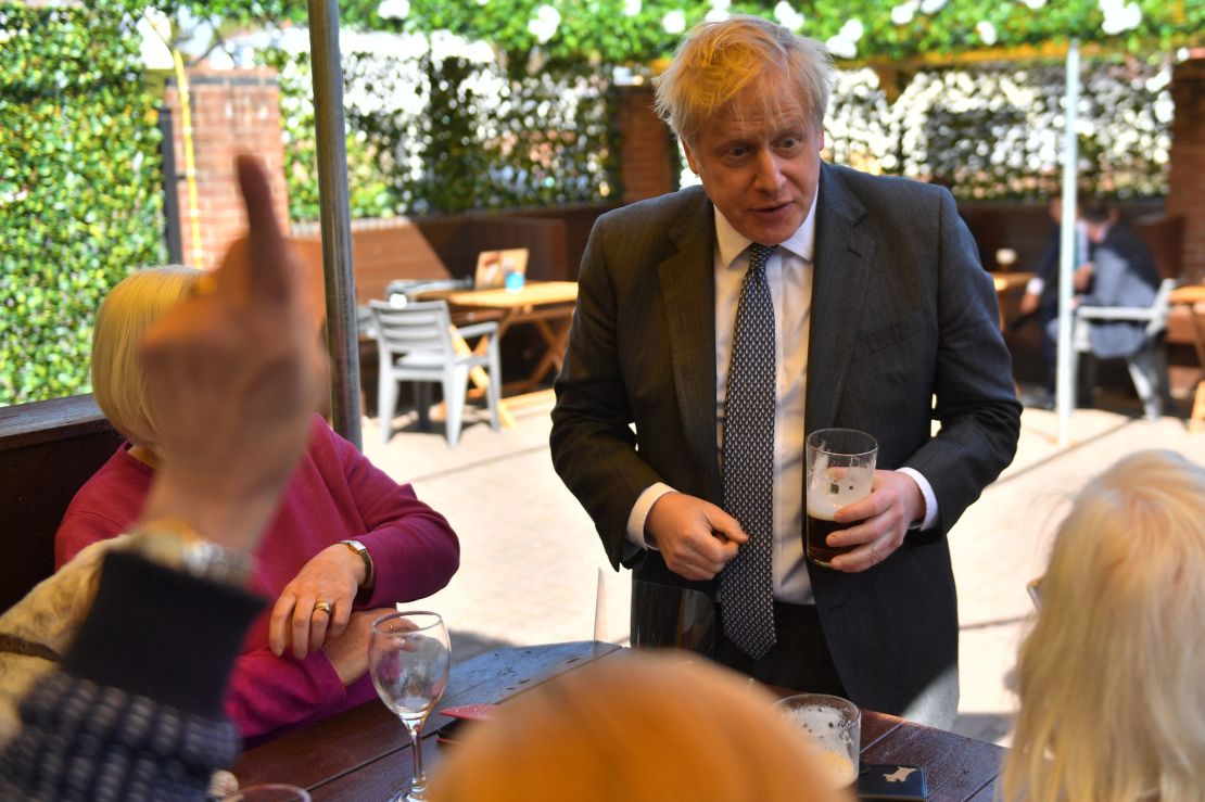 Prime Minister Johnson with customers in the beer garden during a visit to a pub on April 19, 2021.