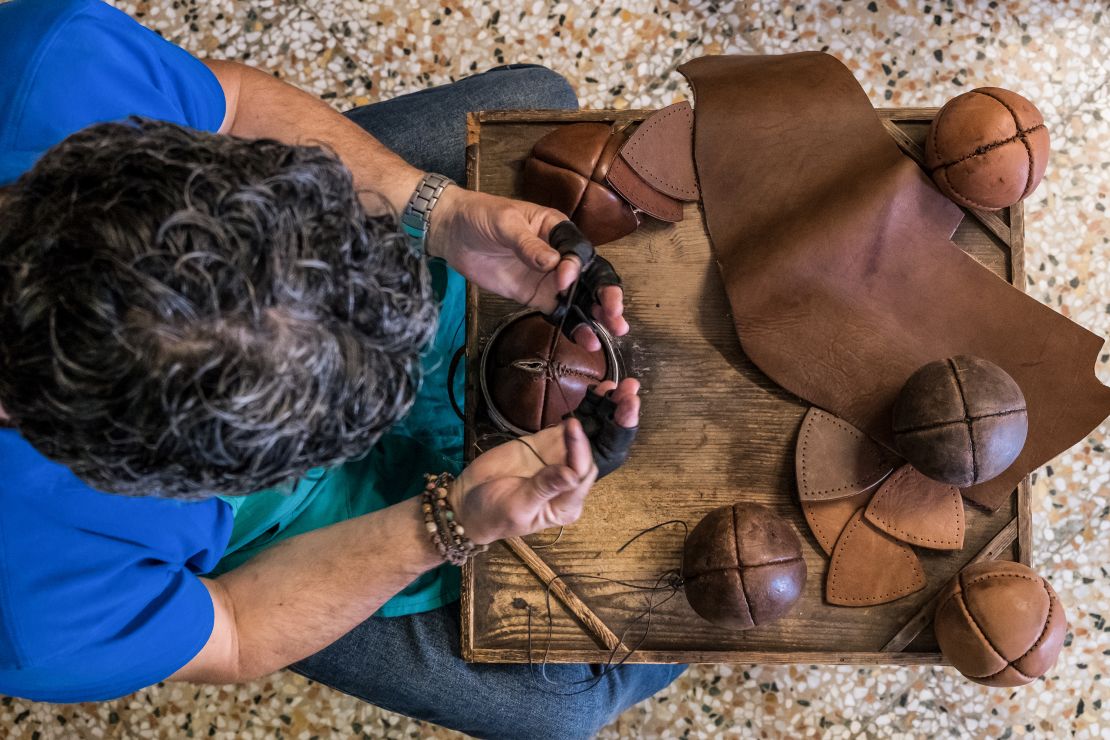 The weighted balls are hand-stitched by artisans, like Treia's Daniele Rango.