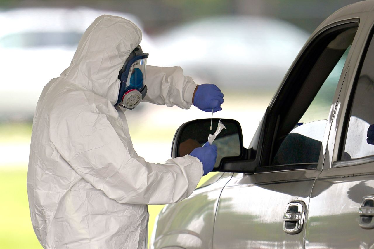 A medical professional administers a coronavirus test at a drive-thru testing center in Houston, on April 2.