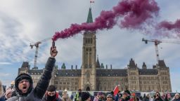 OTTAWA, ON - JANUARY 30: A man screams while holding a smoke firework during a protest against COVID-19 vaccine mandates on Parliament Hill on January 29, 2022 in Ottawa, Canada. Thousands turned up over the weekend to rally in support of truckers using their vehicles to block access to Parliament Hill, most of the downtown area Ottawa, and the Alberta border in hopes of pressuring the government to roll back COVID-19 public health regulations. (Photo by Alex Kent/Getty Images)