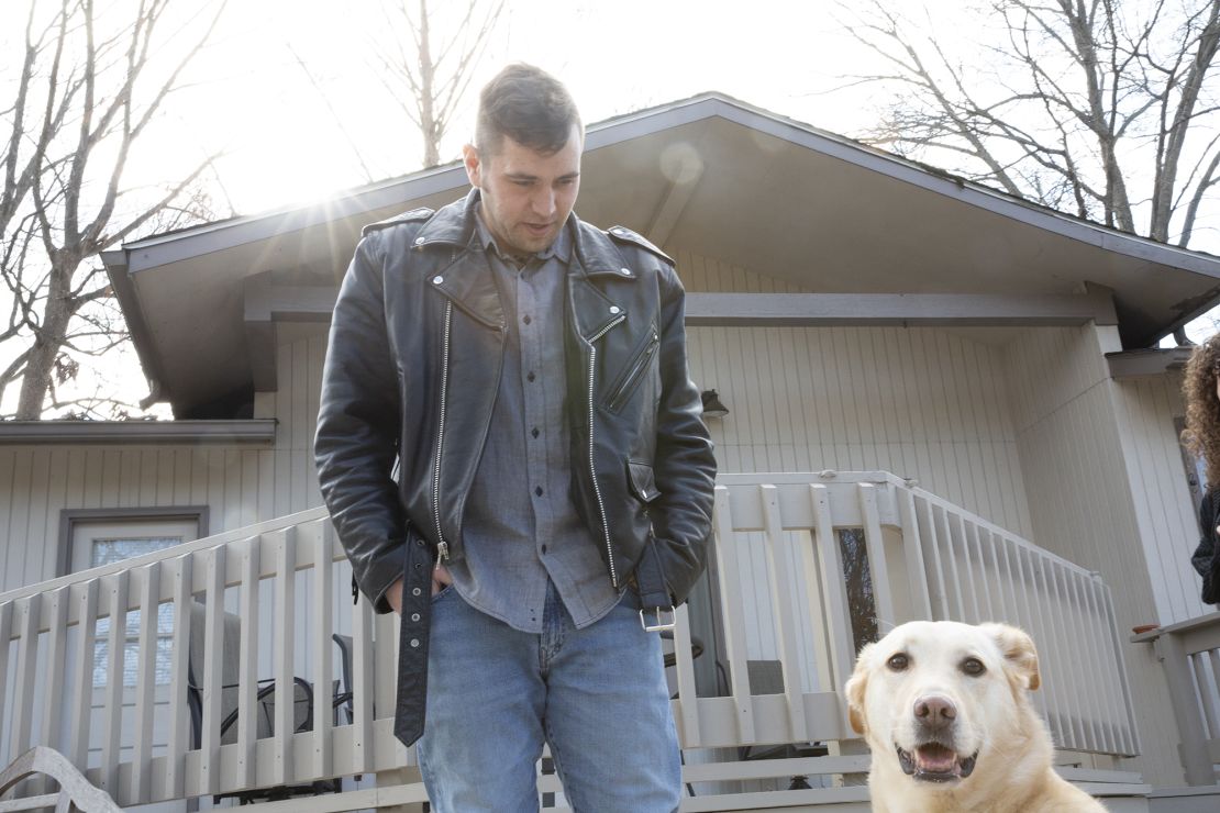 AJ Vanover photographed at his home with his dog.