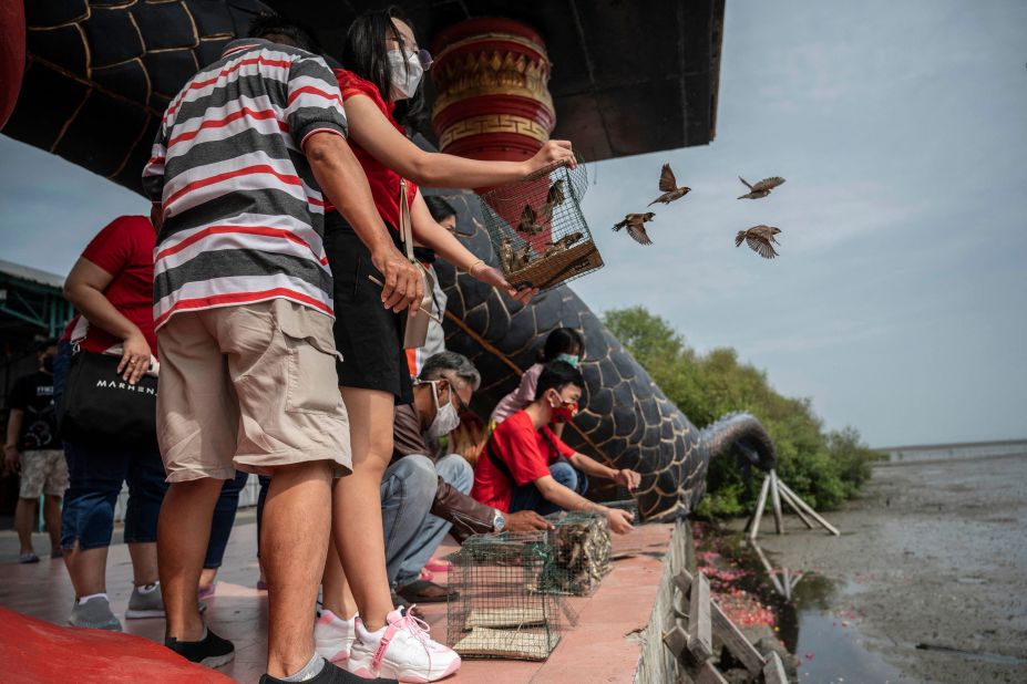 People release birds as they celebrate the start of the Lunar New Year in Surabaya, Indonesia.