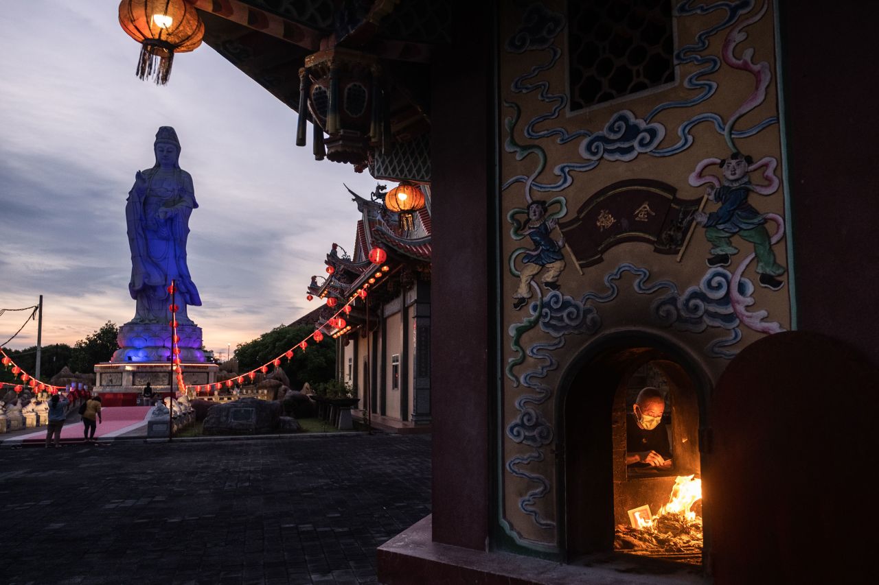 A man burns incense papers during a prayer in Denpasar, Indonesia, on January 31.