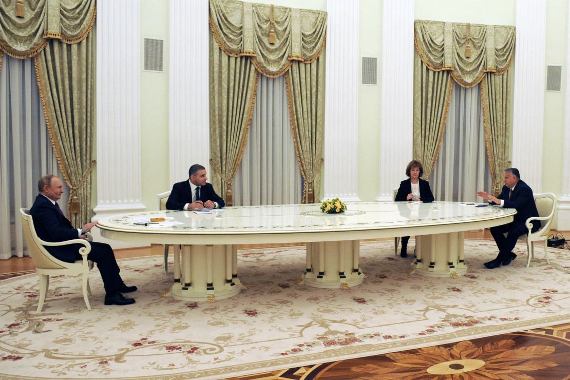 Russian President Vladimir Putin (L) speaks with Hungarian Prime Minister Viktor Orban (R) during their meeting in Moscow on February 1, 2022. 