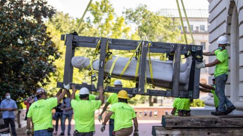 Workers hoist a statue of Jefferson Davis after removing it from the the Kentucky state Capitol in Frankfort on June 13, 2020.