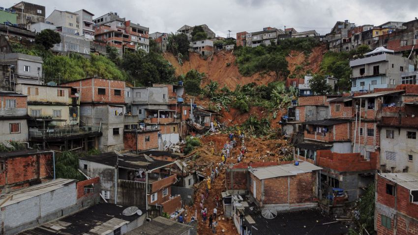 General view of citizens helping firefighters remove mud in search of victims after a landslide caused by heavy rains buried homes in Franco da Rocha, Sao Paulo state, Brazil, on January 31, 2022. - Torrential rains in Brazil's Sao Paulo state between Friday and Sunday left at least 18 people dead, authorities said. (Photo by FILIPE ARAUJO / AFP) (Photo by FILIPE ARAUJO/AFP via Getty Images)