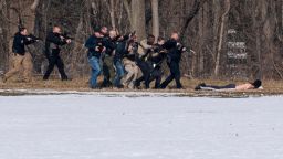 Police approach a person of interest on the south bank of the North River in Bridgewater, Va. following a shooting at Bridgewater College Tuesday, Feb. 1, 2022. (Daniel Lin/Daily News-Record Via AP)