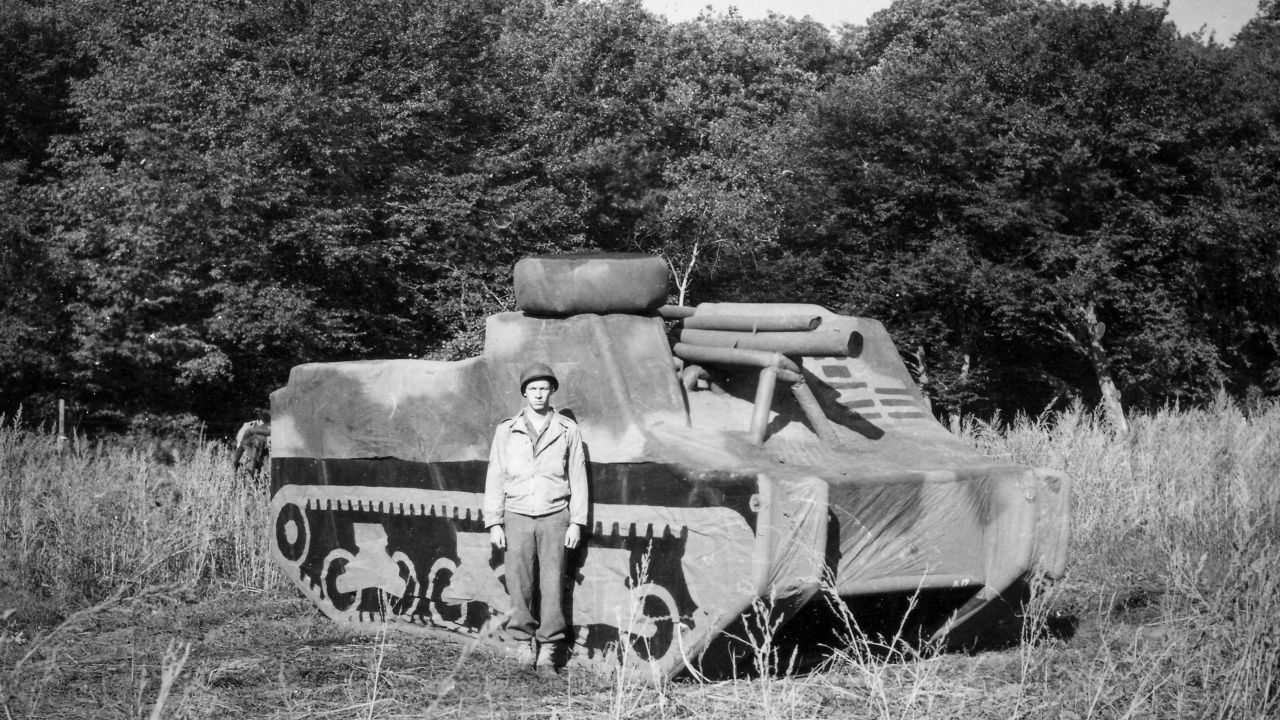 An unknown "Ghost Army" soldier of the 23rd Headquarters Special Troops is pictured before an inflatable M7 Priest self-propelled gun on September 14, 1944, in France.