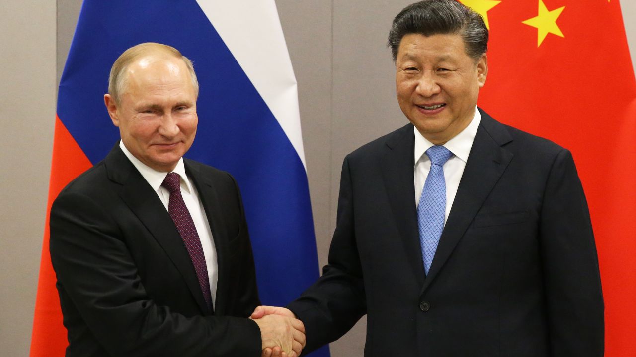 Russian President Vladimir Putin (L) greets Chinese President Xi Jinping (R) during a bilateral meeting on November 13, 2019 in Brasilia, Brazil. 