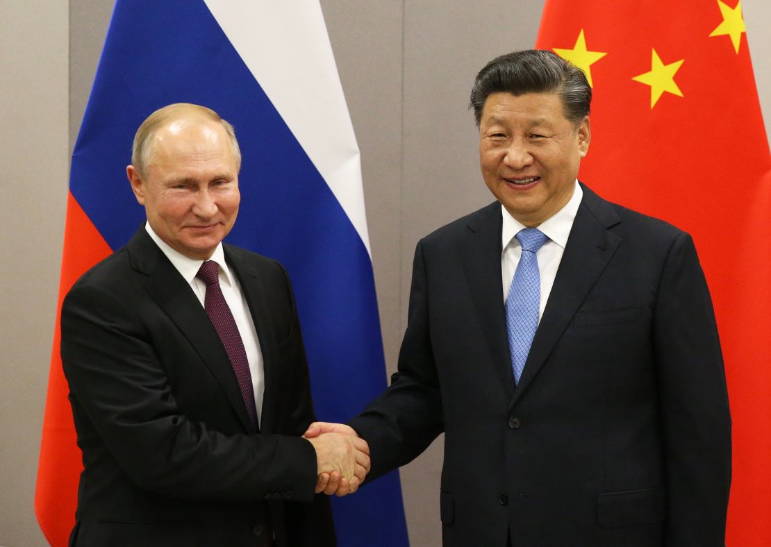 Russian President Vladimir Putin (L) greets Chinese President Xi Jinping (R) during a bilateral meeting on November 13, 2019 in Brasilia, Brazil. 