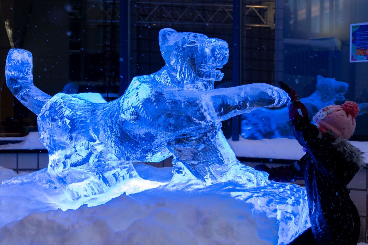 A child touches an ice sculpture in Helsinki, Finland, on Monday, January 31.