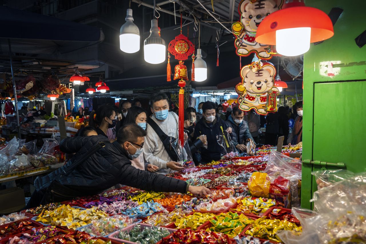 Shoppers purchase festive sweets at a street stall in Hong Kong on January 30.