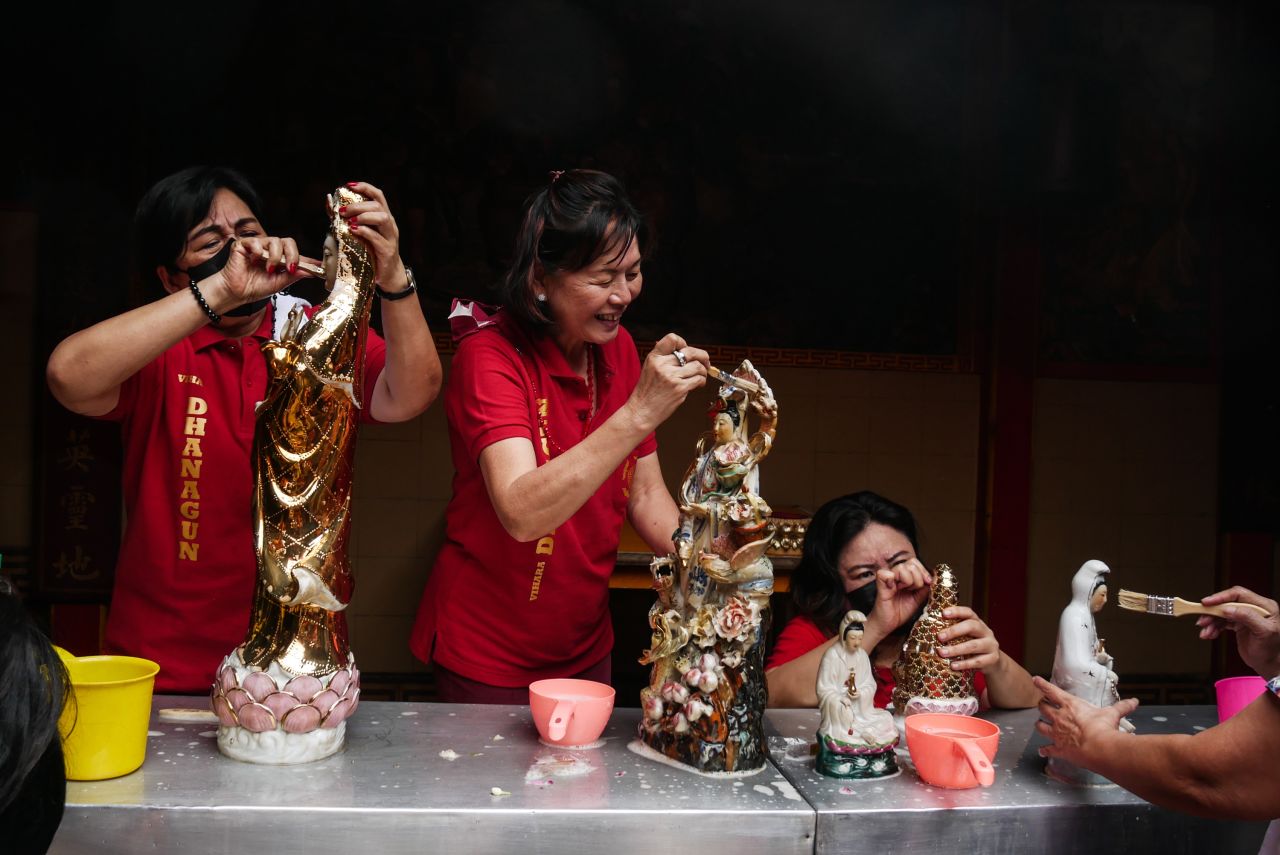 People wash religious statues at a temple in Bogor, Indonesia, on January 27.