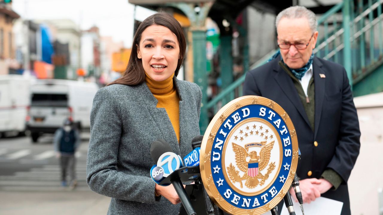 Democratic Rep. Alexandria Ocasio-Cortez speaks as then-Senate Minority Leader Chuck Schumer listens during a press conference in the Corona neighbourhood of Queens in April 2020 in New York City.