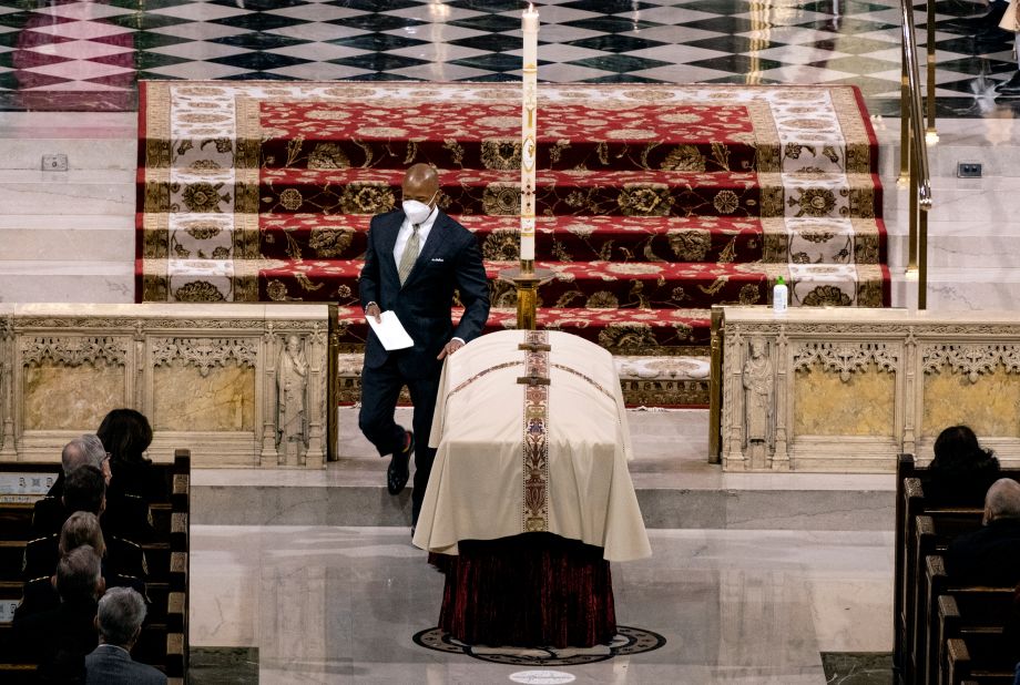 New York City Mayor Eric Adams touches Mora's casket after giving a eulogy at St. Patrick's Cathedral.