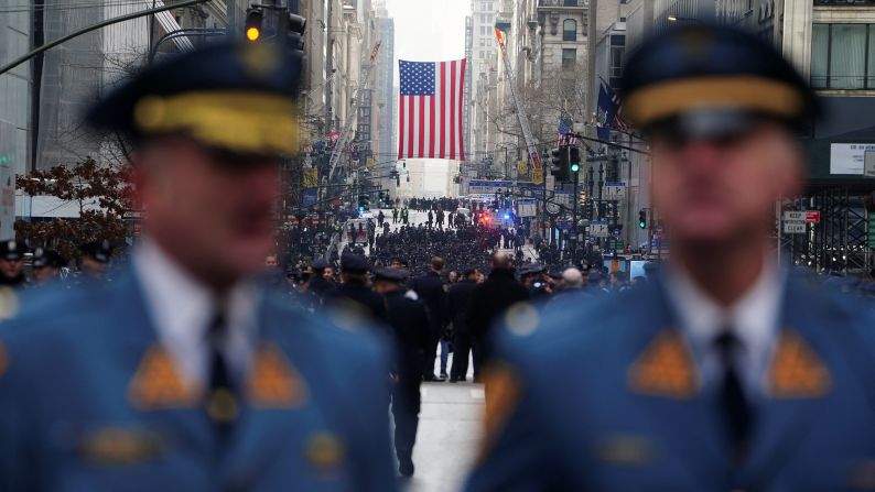 Police officers attend Mora's funeral. 