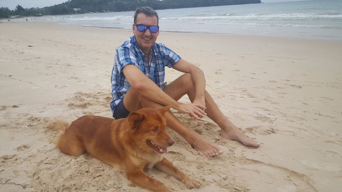 Jonathan relaxes on the beach with a dog named Fox during a house sit in Bang Tao, Thailand in 2018.