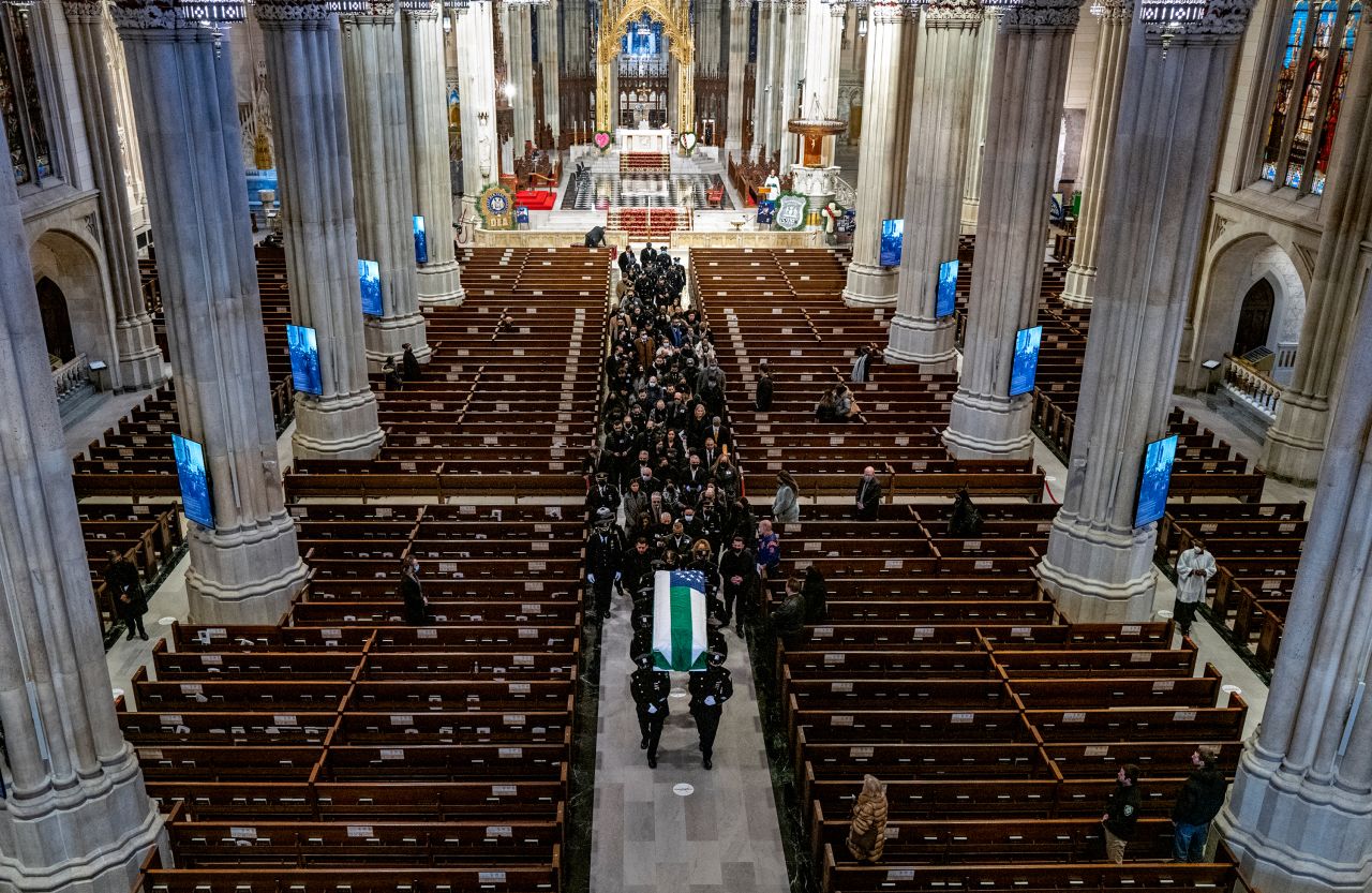 Mora's casket is carried out of St. Patrick's Cathedral following his funeral service. 