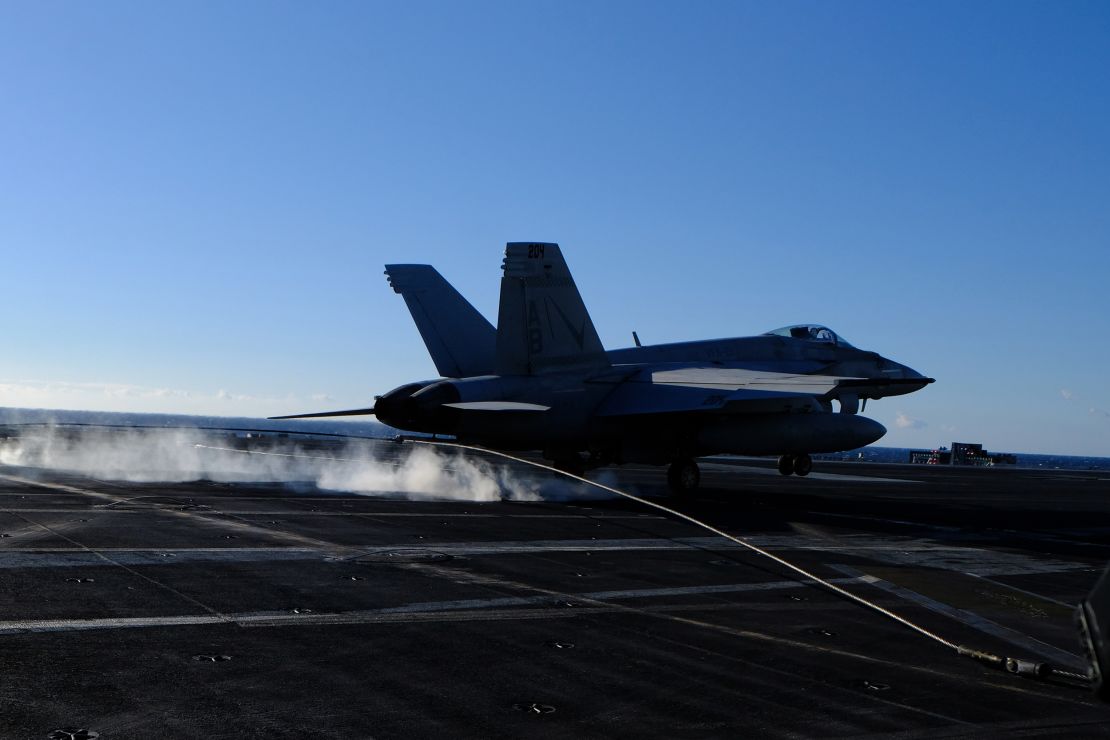 To land on the USS Harry S Truman, the F/A-18 has to catch a wire to help it stop.