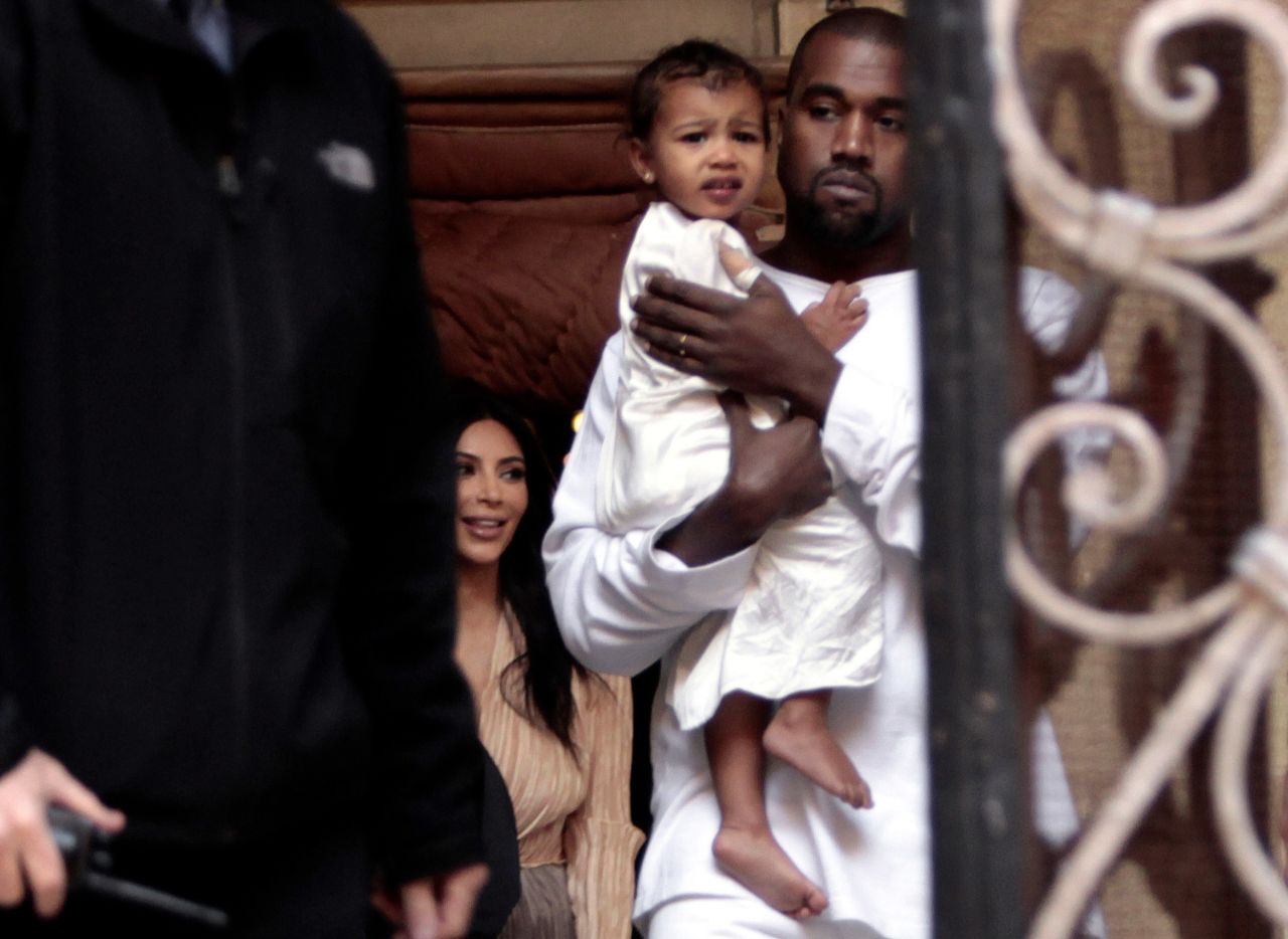 West holds his daughter, North, as he and his wife, Kim, visit a cathedral in Jerusalem in 2015.