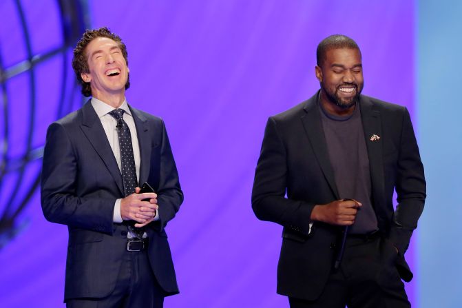 West makes a joke next to pastor Joel Osteen while leading a prayer at Osteen's Lakewood Church in Houston in 2019. West also put on one of his <a href="index.php?page=&url=https%3A%2F%2Fwww.cnn.com%2F2019%2F11%2F16%2Fus%2Fkanye-west-lakewood-church-ticket-scalping-trnd%2Findex.html" target="_blank">"Sunday Service" performances</a> at the church.