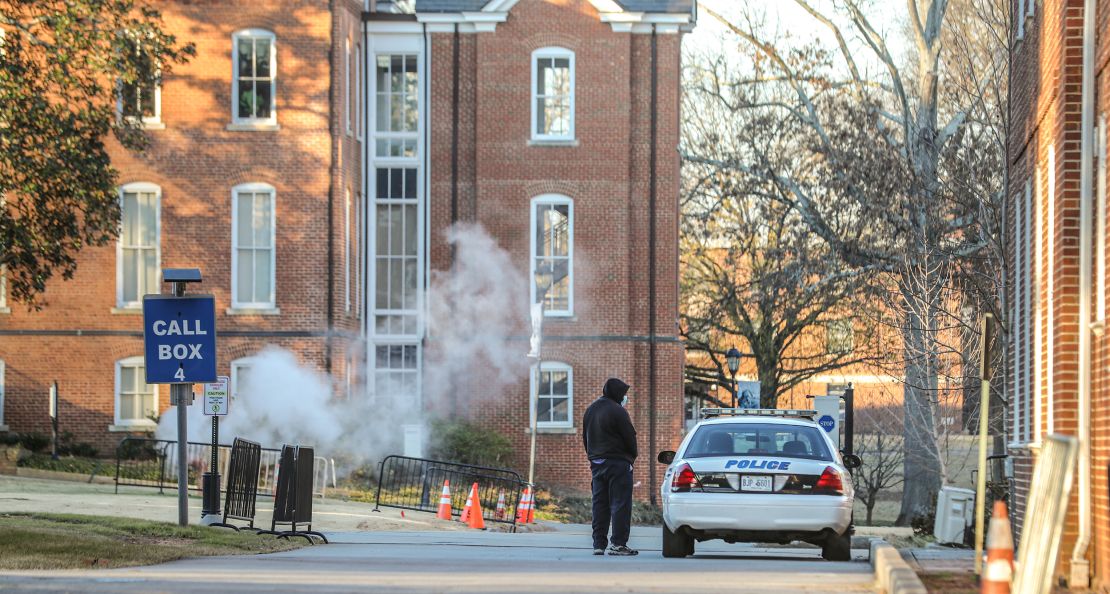 A man speaks with an officer outside Spelman College, which received a bomb threat Tuesday.