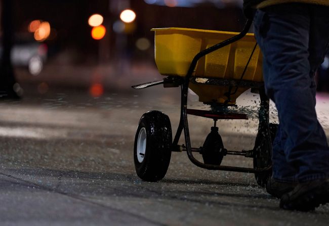 Salt is spread on the sidewalks in downtown Indianapolis.
