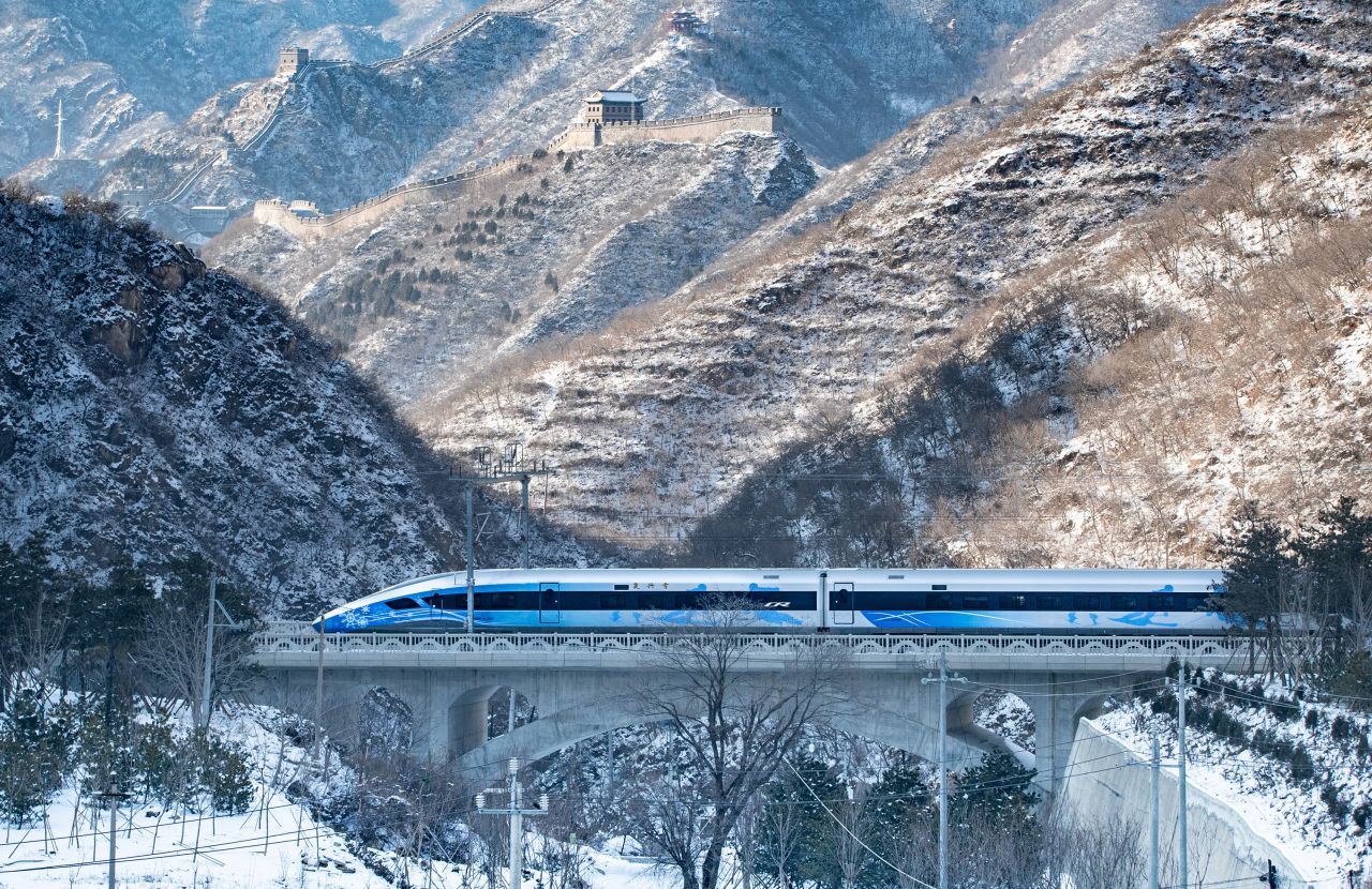 The new Beijing-Zhangjiakou high-speed train travels past the Juyongguan section of the Great Wall on January 25, 2022. 