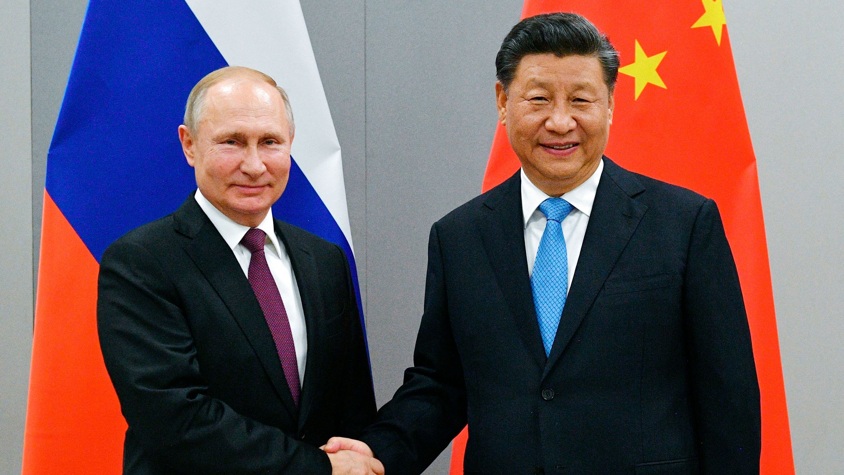 Russian President Vladimir Putin and China's President Xi Jinping shake hands at the BRICS Summit in Brazil in November, 2019. 