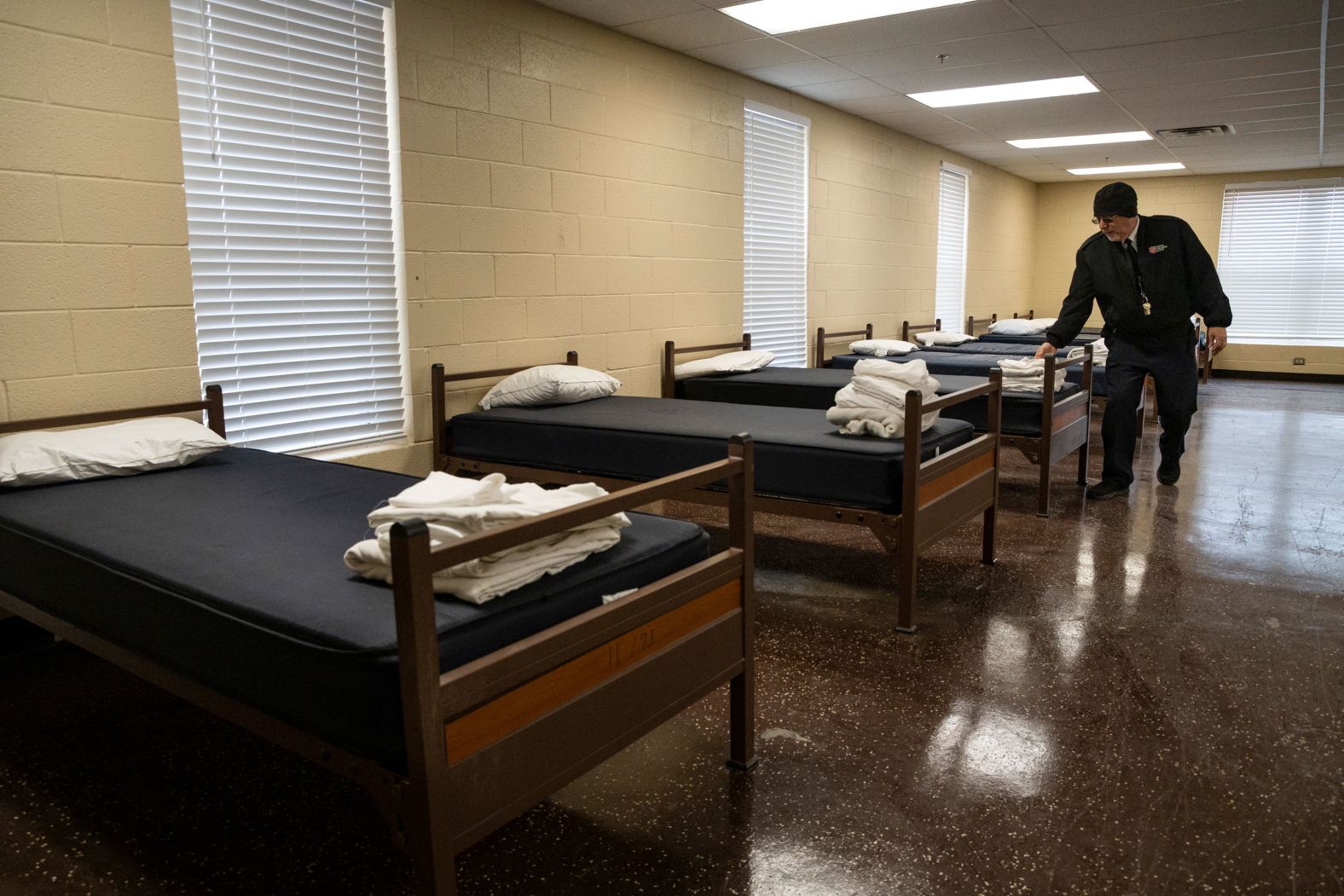 Salvation Army Maj. Luis Melendez inspects beds at the Mabee Red Shield Lodge in Odessa, Texas, as the shelter prepared to open as an emergency shelter on February 2.