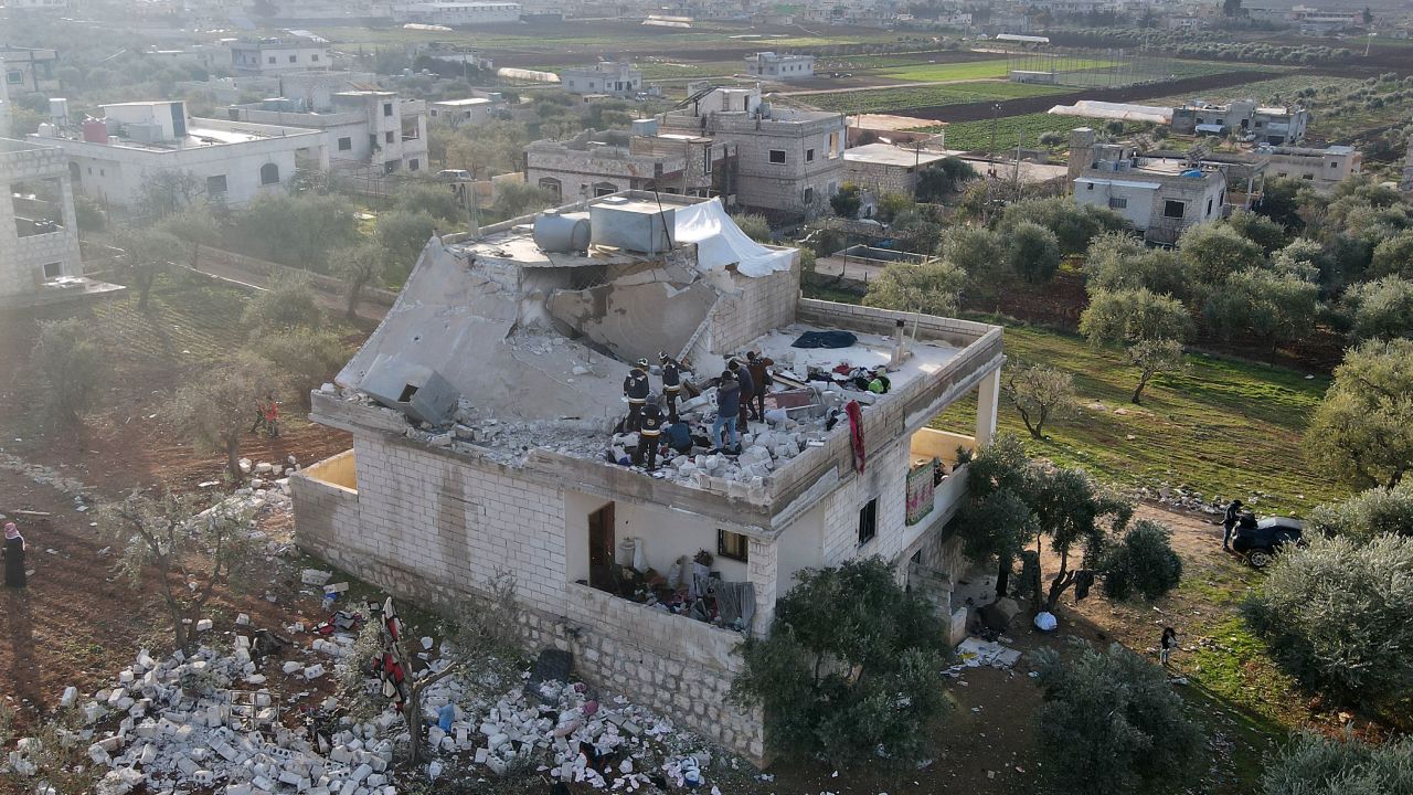 Syrians gather at the scene following the overnight raid by US Special Forces.