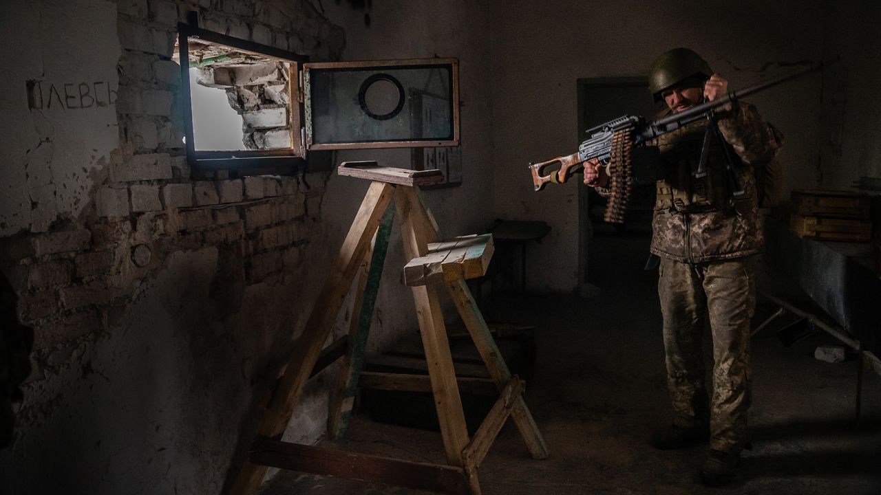 Denis, a soldier in the Ukrainian army, holds a machine gun in Marinka, Ukraine. The 38-year-old was previously a welder. Now he's on the front lines just a few hundred yards away from Russian-backed separatists.