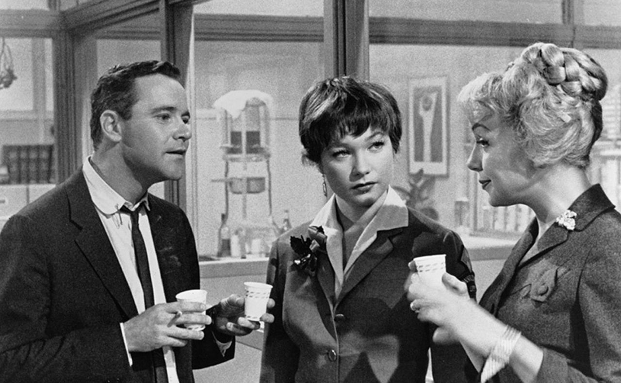 <strong>"The Apartment" (1961):</strong> Long before "Mad Men," Billy Wilder's "The Apartment" skewered corporate life of the early 1960s. Up-and-comer Jack Lemmon stays busy loaning his apartment key to company men who need a place to cheat on their wives. He falls for Shirley MacLaine, center, who is having an affair with one of the bosses ("My Three Sons' " Fred MacMurray in an unsympathetic role).
