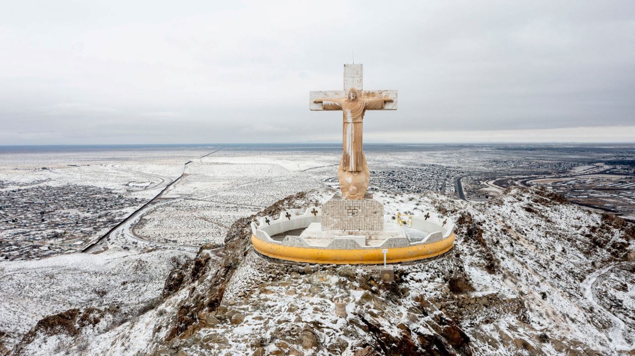 Snow covers a limestone statue of Jesus Christ at the summit of Mount Cristo Rey in Sunland Park, New Mexico.