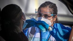 Los Angeles, CA - January 25: A healthcare worker Desirae Velasquez administers a COVID19 test to Maria Lemus at a testing facility established by Total Testing Solutions in Boyle Heights on Tuesday, Jan. 25, 2022 in Los Angeles, CA.