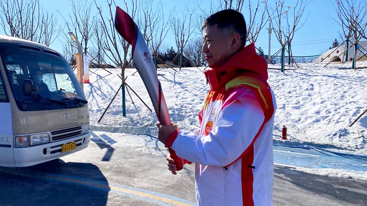 Qi Fabao, a regimental commander in the People's Liberation Army, carrying the Olympic torch on Wednesday Feb 2, 2022 at Olympic Forest Park, Beijing, China.