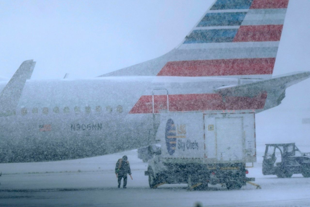 Snow falls on a ground crew working at the Dallas/Fort Worth International Airport on Thursday, February 3. A <a href="https://www.cnn.com/2022/02/02/weather/gallery/winter-storm-february/index.html" target="_blank">winter storm</a> has been dropping significant snowfall this week in parts of the Midwest and South.