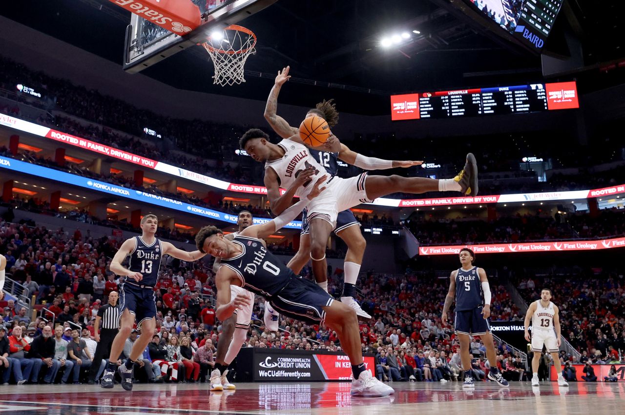 Louisville's Jae'Lyn Withers crashes into Duke's Wendell Moore, bottom, during a college basketball game in Louisville, Kentucky, on Saturday, January 29.