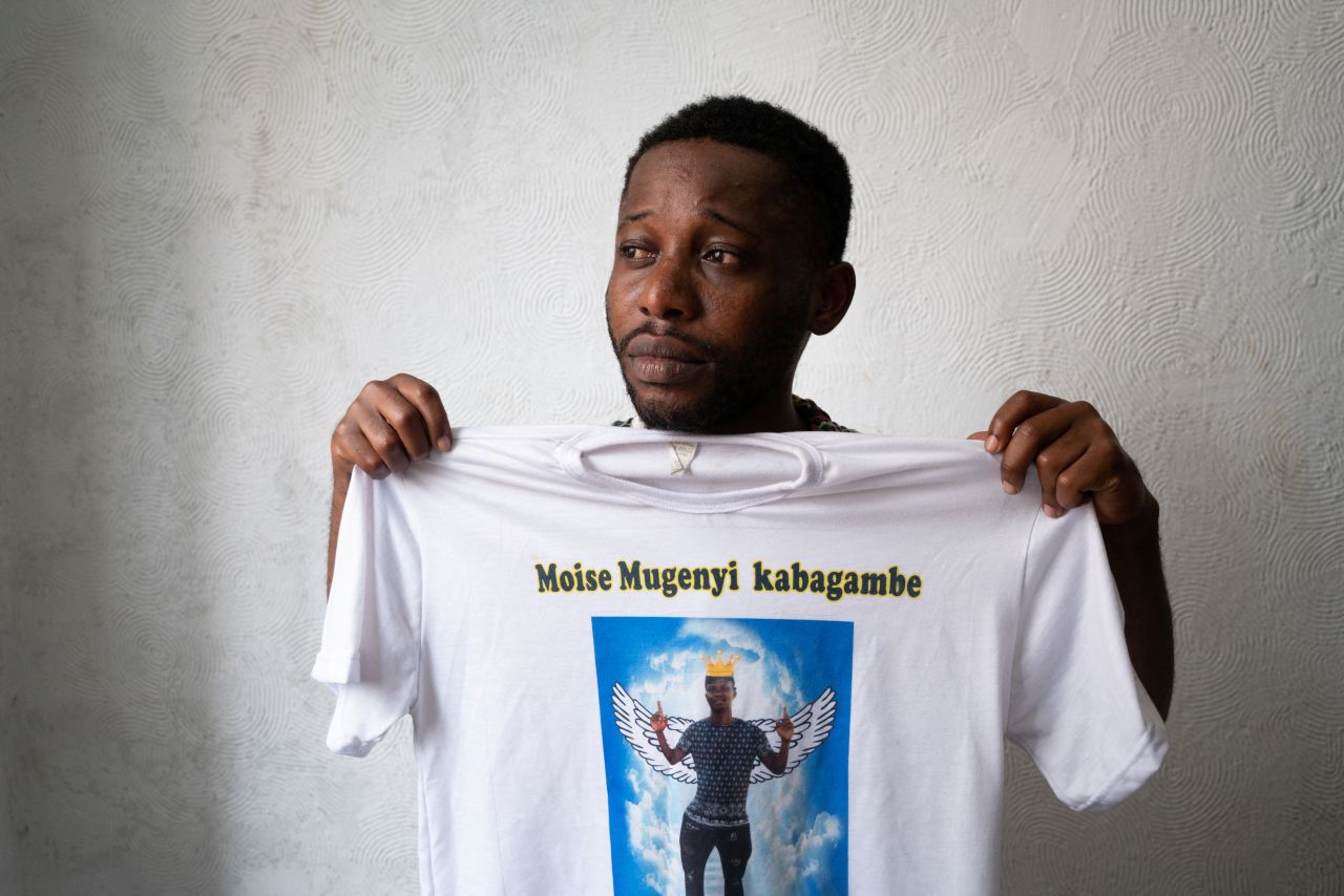 Chadrac Kembilu, a friend of Moise Kabagambe, holds up a T-shirt with Kabagambe's image on Wednesday, February 2. Kabagambe, a 23-year-old Congolese migrant, <a href="https://www.cnn.com/2022/02/02/americas/congolese-migrant-murdered-brazil-lgs-latam-intl/index.html" target="_blank">was beaten to death last month</a> at a beachside kiosk in Rio de Janeiro. Three men have been arrested in connection with his death, police said.