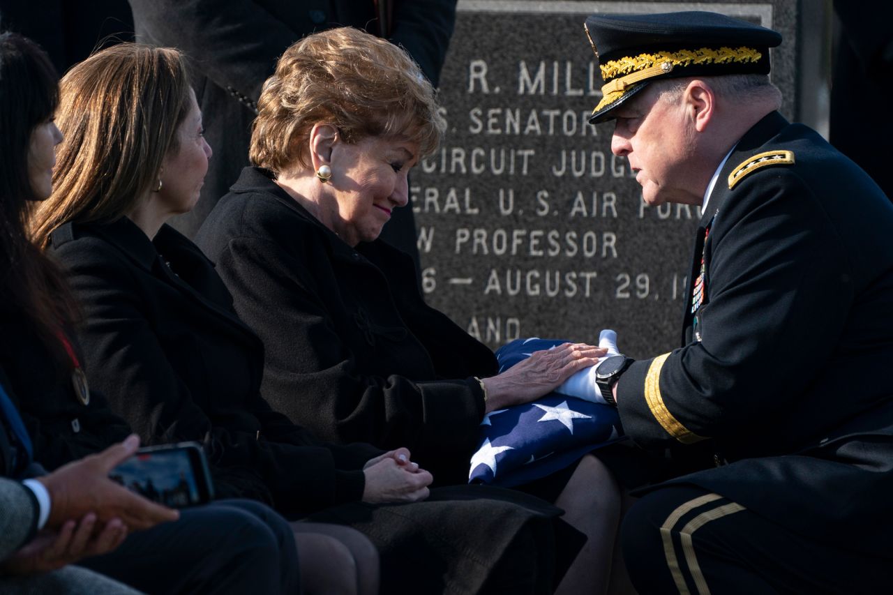 US Army Gen. Mark Milley, the chairman of the Joint Chiefs of Staff, presents a flag to former US Sen. Elizabeth Dole during the burial service for her late husband, <a href="https://www.cnn.com/2021/12/05/politics/gallery/bob-dole/index.html" target="_blank">Bob Dole,</a> on Wednesday, February 2. Bob Dole, a former US senator and presidential candidate who died in December, was being buried at Arlington National Cemetery. 