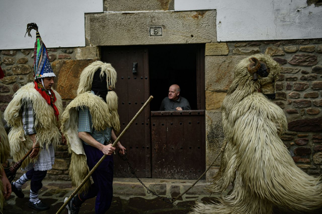 A resident looks out from his home during a Carnival celebration taking place between the Spanish villages of Ituren and Zubieta on Monday, January 31.