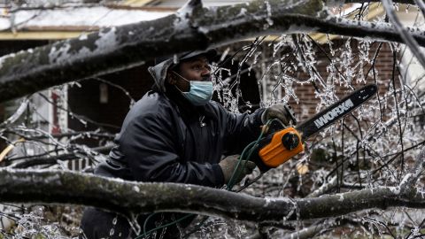 A man works to clear a downed tree on February 3 in Memphis, Tennessee.