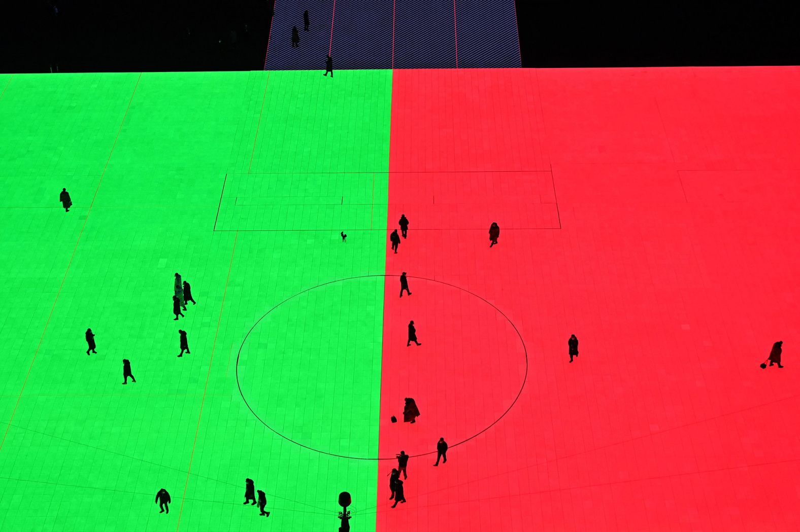 People walk inside the stadium before the start of the opening ceremony.