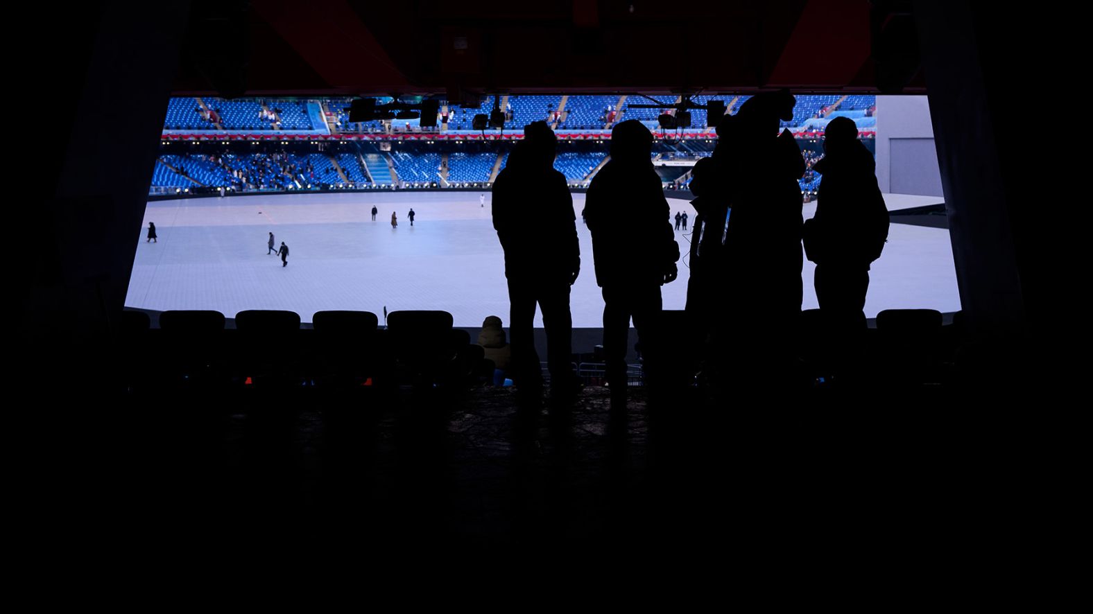 People wait in a gangway ahead of the opening ceremony.