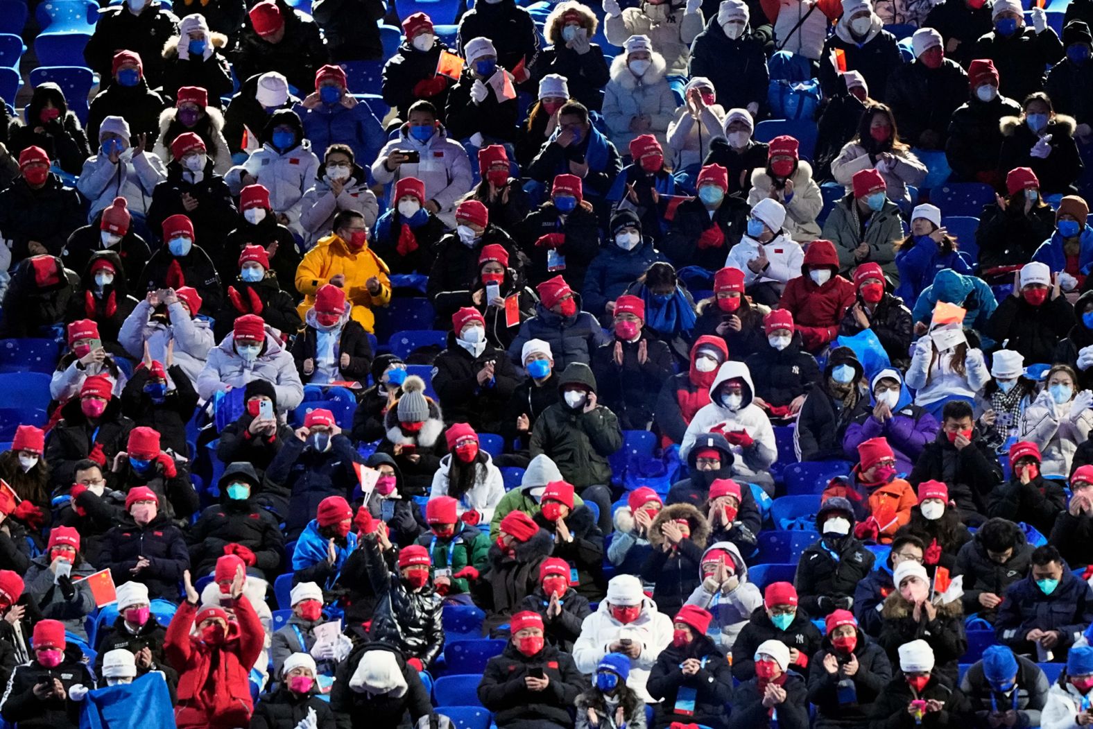 Spectators wait for the start of the ceremony. Tickets were not sold to the general public due to the coronavirus pandemic.