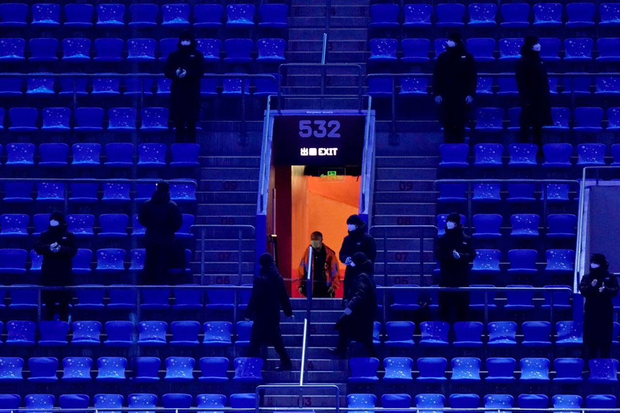 Security personnel stand guard inside the stadium.