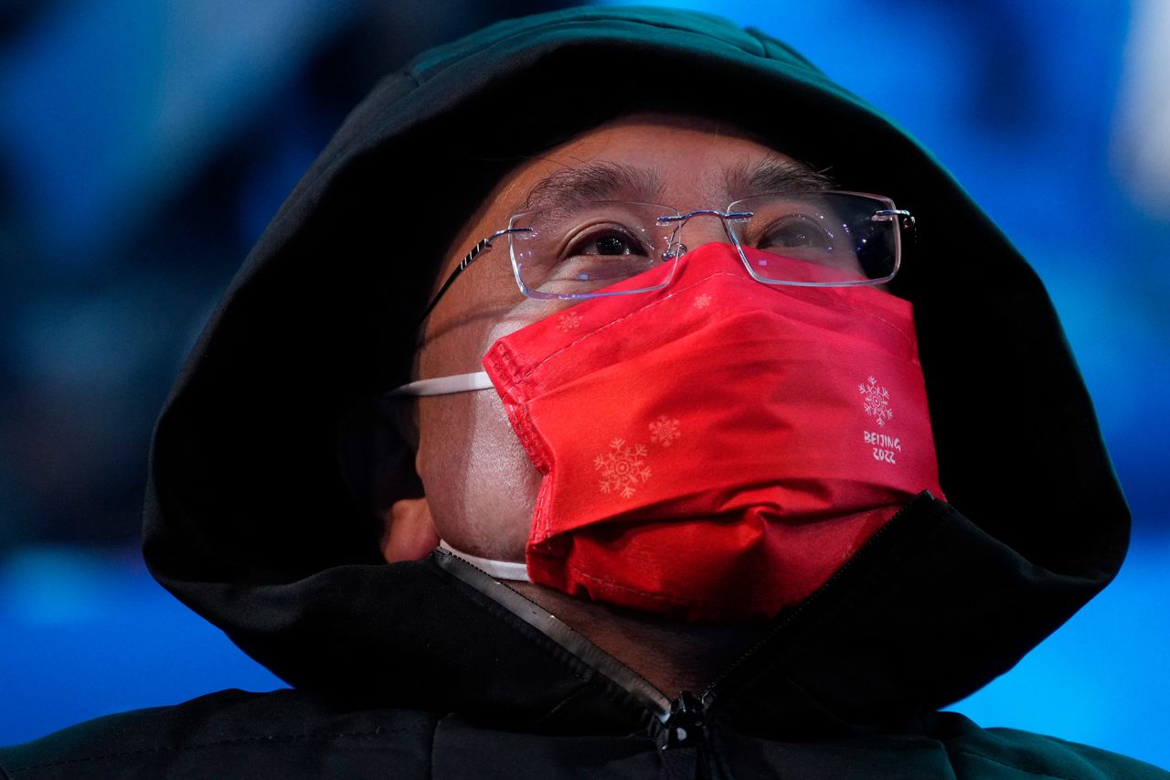 A man wears a face mask at the event. This is the second Olympics to be held during the coronavirus pandemic.